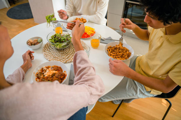 istock Hispanic Family Eating Lunch at Home 1365222012
