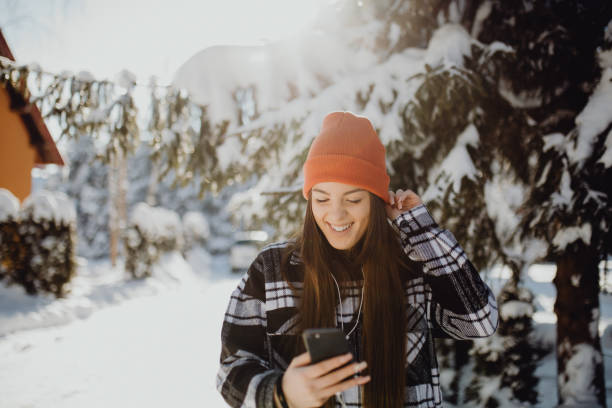 istock young woman using her phone and walk in nature 1365222618