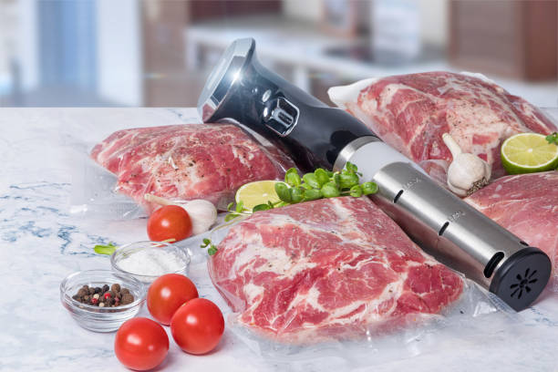 Vegetables and meat and sous-vide sauce cooker. stock photo