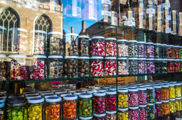 A showcase with colored candies in glass jars