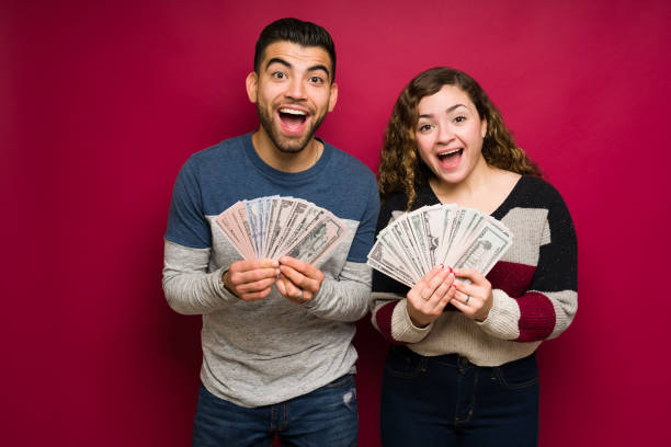 istock Hispanic man and woman feeling very rich 1365224405