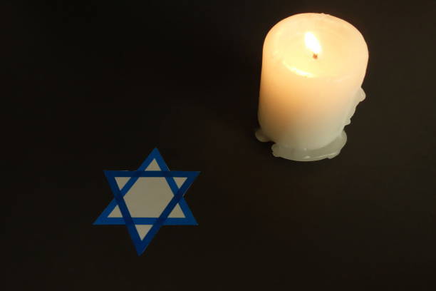 Man hand holding yellow candle