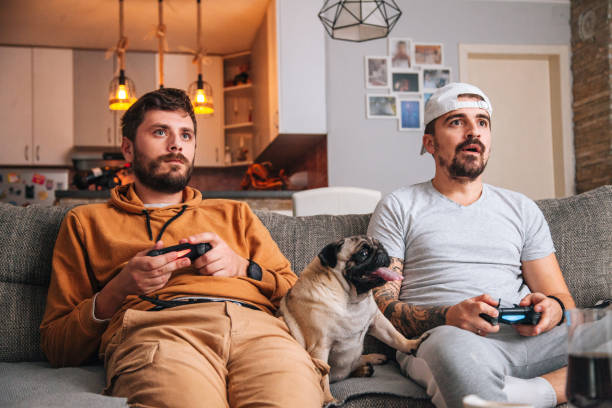 istock Excited friends playing video games 1365224460