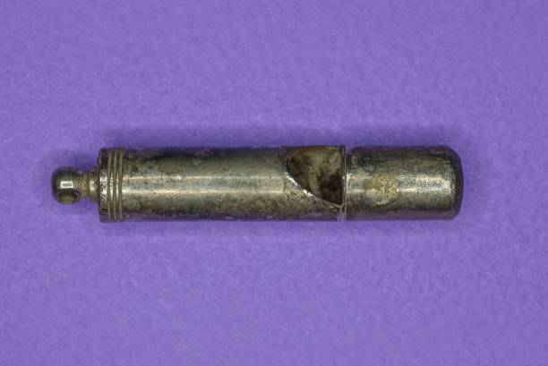 istock gray metal whistle lies on a purple table 1365224562
