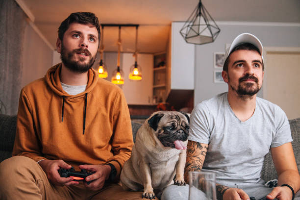 istock Excited friends playing video games 1365224680