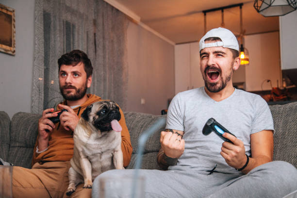 istock Excited friends playing video games 1365224801