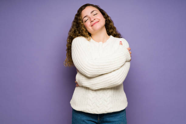 Thankful woman embracing herself