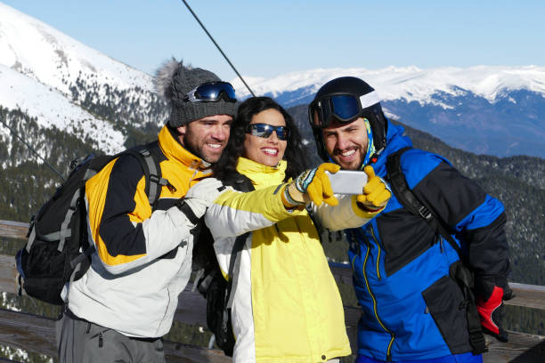istock Three happy friends taking selfie in the mountains 1365226077