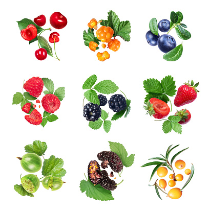 Set of various berries with leaves isolated on white background
