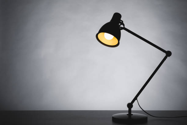 istock desk lamp silhouette, gray background with copy-space 1365227448
