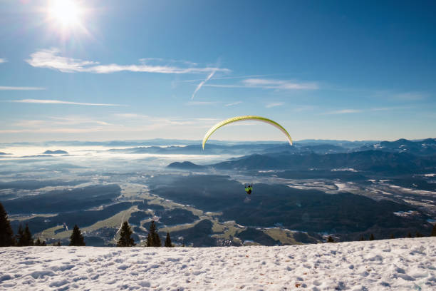 istock Paragliding in winter at mountains 1365227587