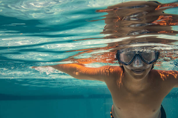 istock Boy having fun diving in the pool 1365228956