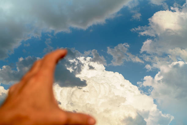 The unfocused hand extended to the sky. Concept of hope and divine help