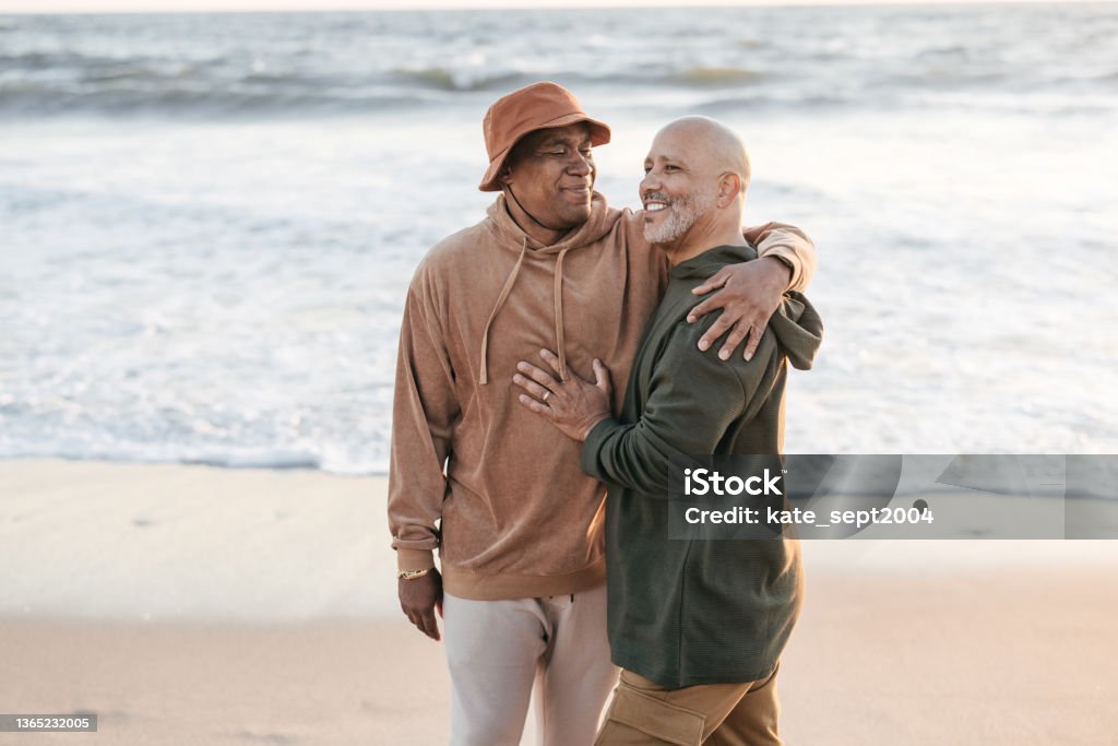 Seek out activities that bring you joy Senior  gay couple  on the beach LGBTQIA People Stock Photo