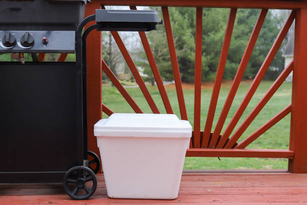 A styrofoam ice cooler on a patio deck in the summer stock photo