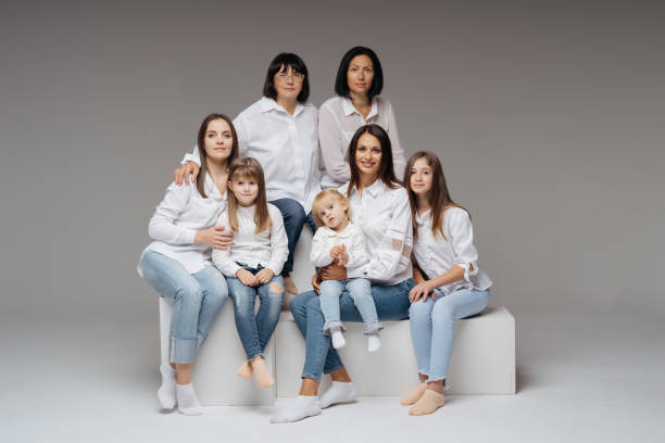 istock Women of three generations posing on gray 1365233313