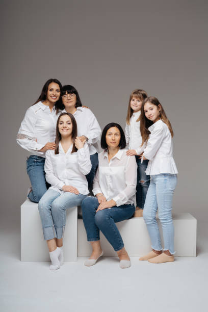 istock Women of three generations posing on gray 1365233329