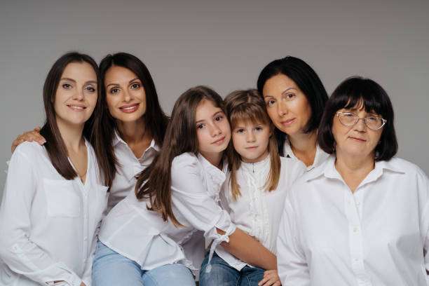istock Women of three generations posing on gray 1365233337