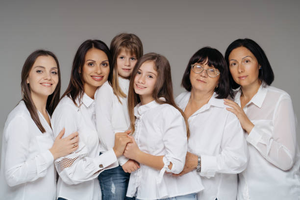 istock Women of three generations posing on gray 1365233355