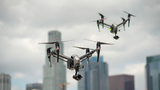 Two DJI Inspire 2 drones flying with downtown Los Angeles in the background. Taken March 24, 2018.