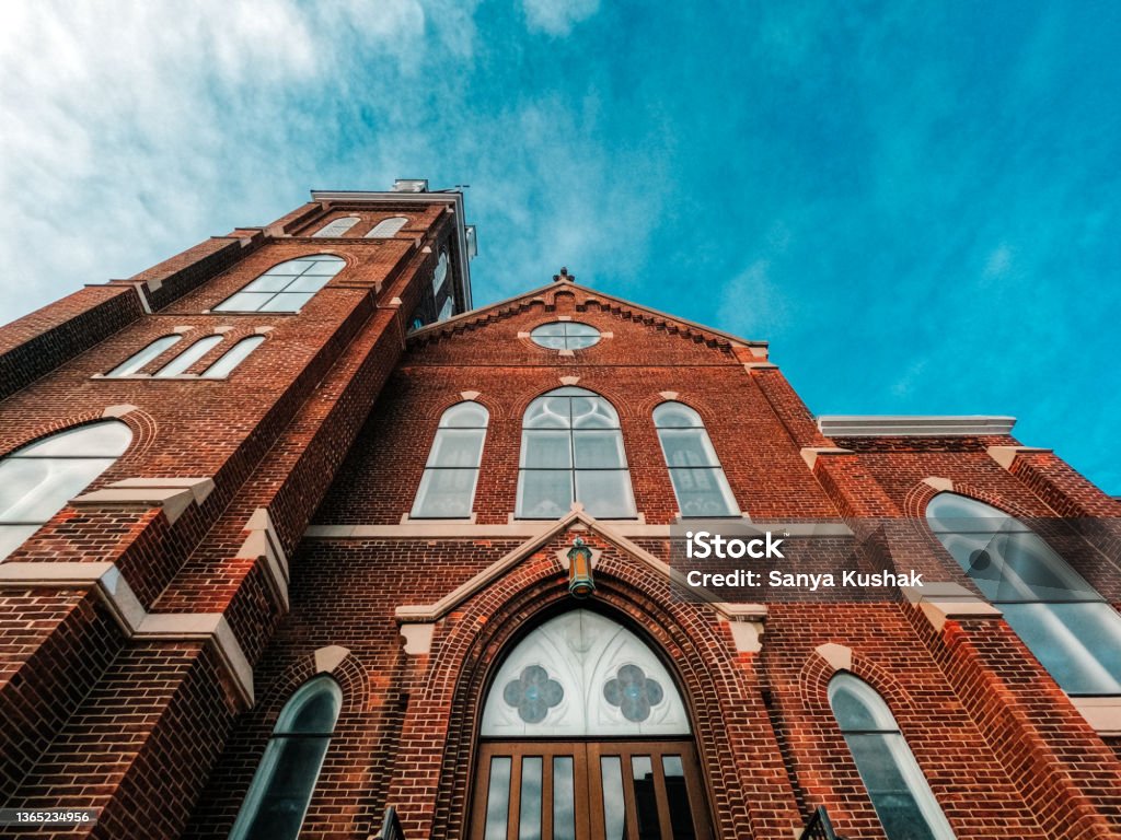 Historic Church Cathedral Reaching Towards the Sky. A majestic ornate old church stands tall against a winter sky. Set in the downtown historical district. Church Stock Photo