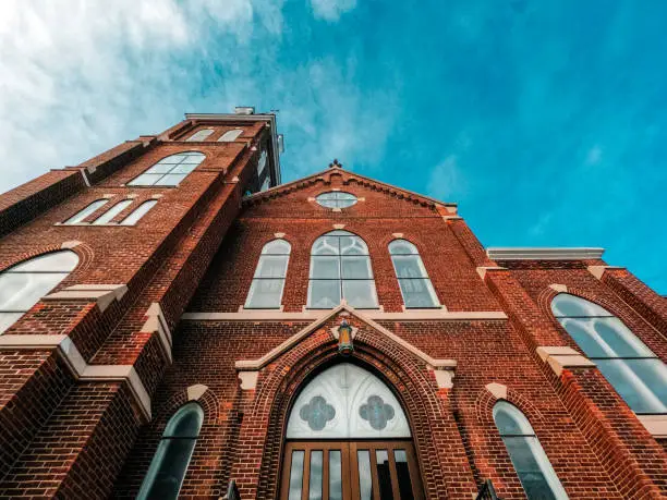 A majestic ornate old church stands tall against a winter sky. Set in the downtown historical district.