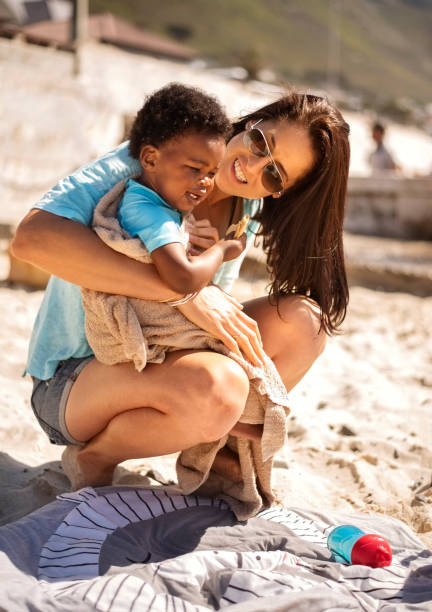 istock Mother and daughter on the beach on a summer day 1365236292