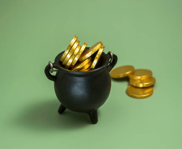 istock pot with leprechaun gold on a green background. St. patrick's day concept 1365238552