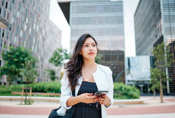 istock Young business woman using mobile phone 1365239134