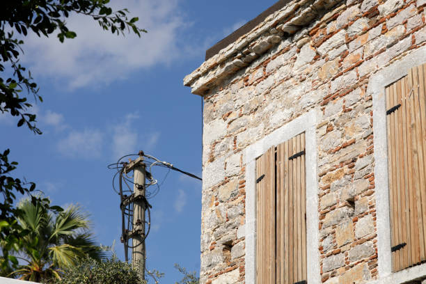 Old stone house with wooden shutter closed