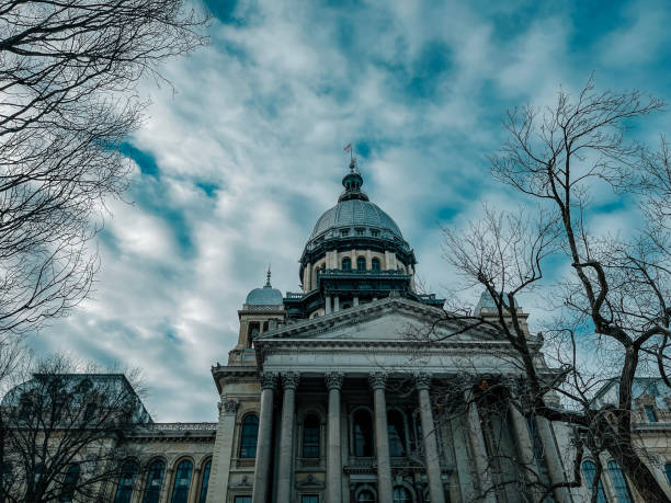 Front View of the Illinois State Capitol Building in Springfield, IL USA The Capitol dome stands tall against a winter afternoon cloudscape. Architectural details of the Illinois State Capitol Building in Springfield, Illinois. Bare winter trees line the perimeter. illinois state capitol stock pictures, royalty-free photos & images