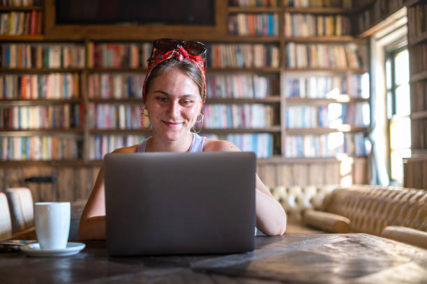 istock Woman working on laptop in a library 1365242947