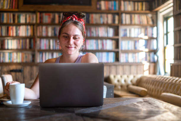istock Woman working on laptop in a library 1365242952