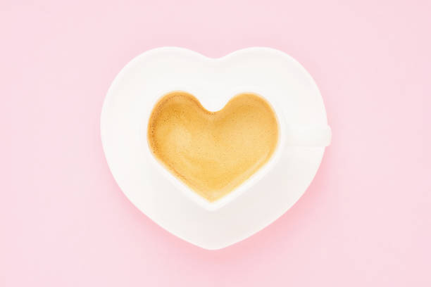 istock Coffee in heart shape mug on a light pink background. Valentine's day concept. Top view, copy space 1365244830