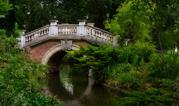 Ancient bridge in the park of Paris. France.