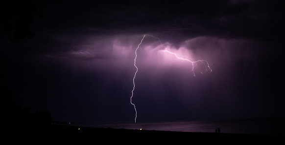 A lightning bolt strikes through a microburst in a severe thunderstorm over Phoenix, Arizona