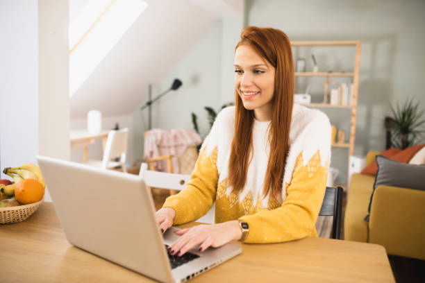 istock Young woman freelancing from home 1365249401