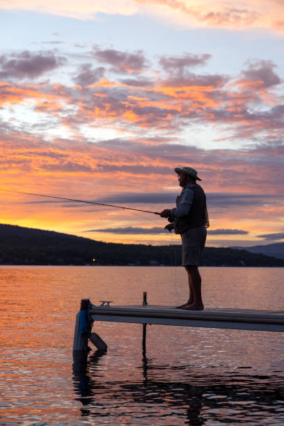 istock Senior Man Fly-Fishing at Sunset 1365250720