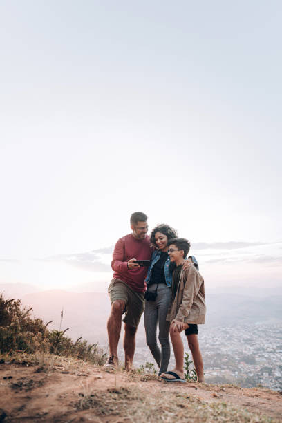 istock Family using cell phone outdoors 1365253311