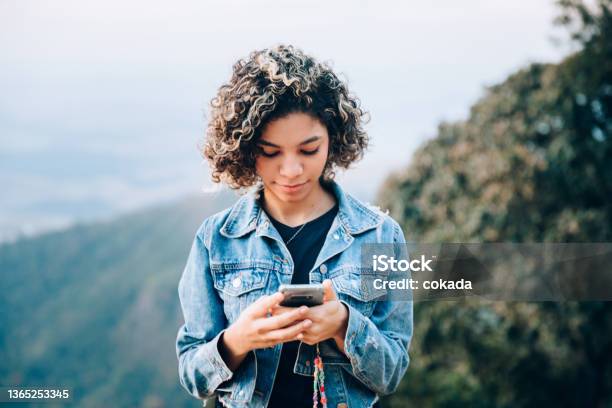 Teenager Using Cell Phone Outdoors Stock Photo - Download Image Now - Using Phone, Teenager, Adolescence