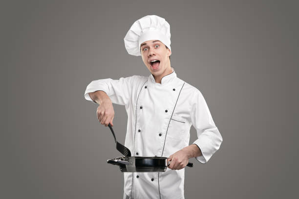 istock Comic man cooking food in pan 1365253722