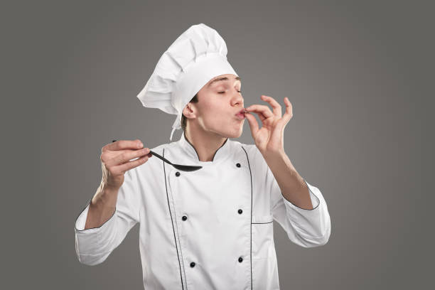 istock Young cook approving tasty dish 1365253739