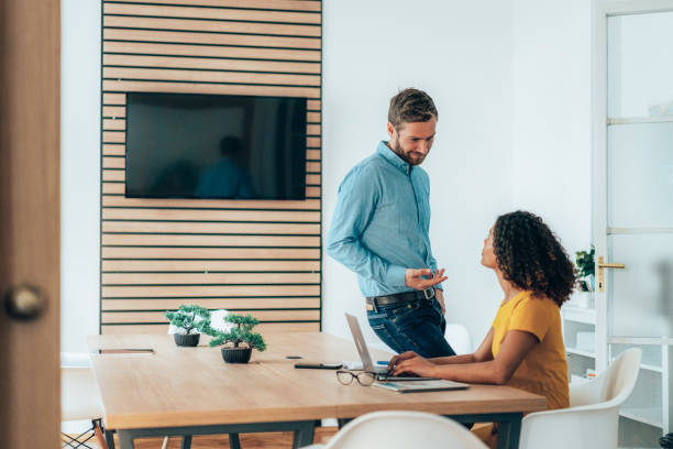 istock Two business persons talking in the office 1365255768