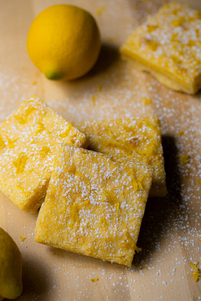 istock Lemon bars and ingredients laid out on wood countertop 1365257550