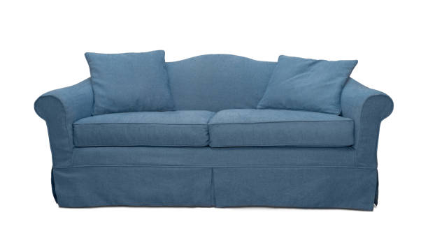 istock Navy blue sofa with pillows isolated on white background. Dark blue textile couch isolated 1365258345