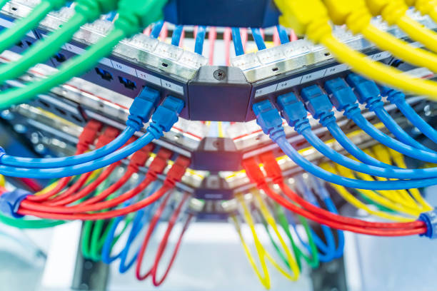 server rack with colorful internet patch cord cables connected to black patch panel in data server room - network server rack data center in a row imagens e fotografias de stock