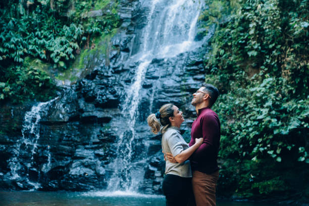 istock Romantic couple at the waterfall 1365264320