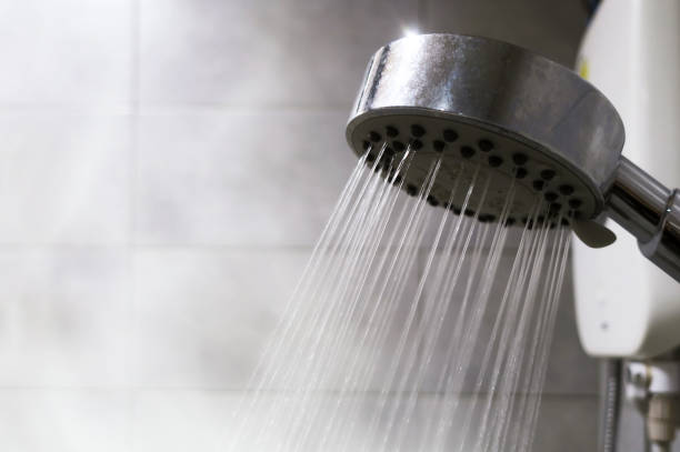 Many small water stream from shower Many small water stream from shower in bathroom with warm smoke vapor for refresh and cleaning shower head stock pictures, royalty-free photos & images
