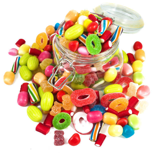 Glass jar full of candies isolated in white background stock photo