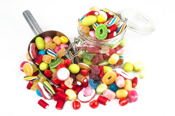 istock Candies in glass jar on white background 1365265667